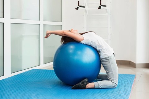 Female patient using exercise ball