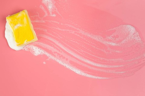 Top view sponge with foam pink background