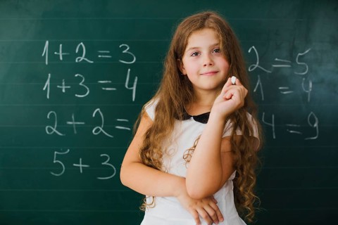 Schoolgirl smiling blackboard class