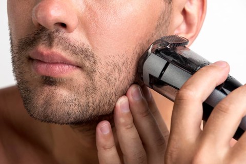 Man shaving with black trimmer