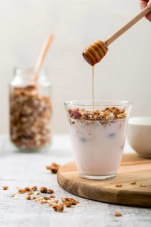 Front view yogurt with granola honey