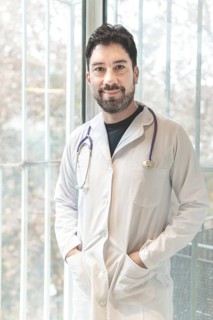 Portrait of latin doctor posing in his office