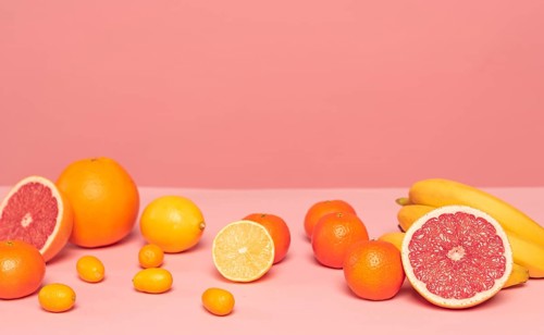 Assortment citruses pink table