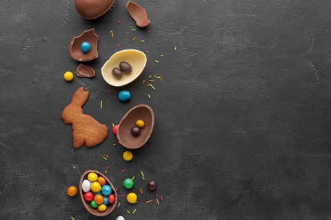 Top view chocolate easter egg with candy bunny shaped cookie