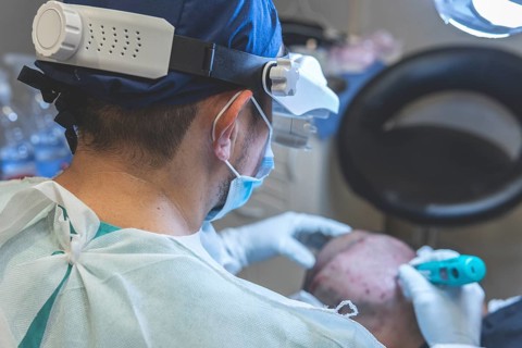 Hair transplant. Surgeons in the operating room carry out hair transplant surgery