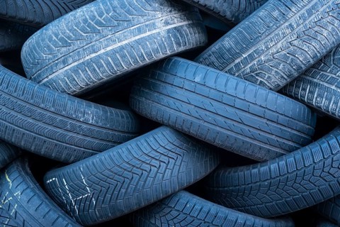 Pile of worn old tyres from passenger cars