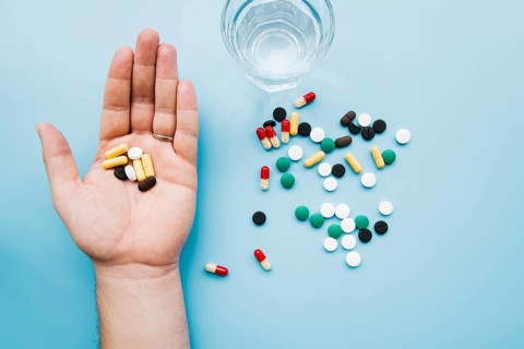 Top view hand holding pills