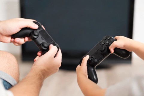 Front view father son playing controllers