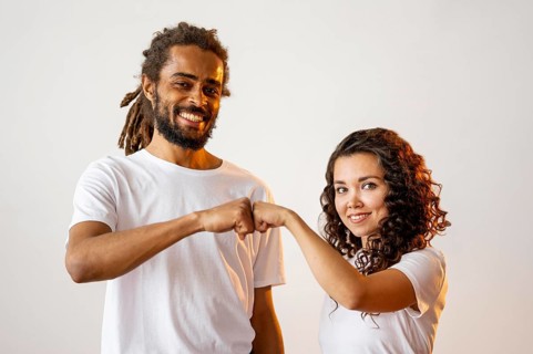 Different racial people fist bumping