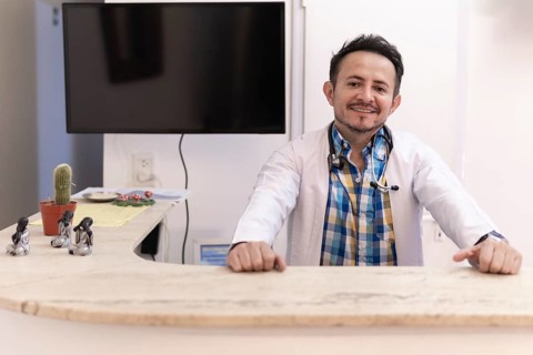 Latino doctor in the reception area of his clinic