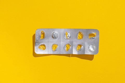 Empty tablet blister pack against a monochrome background
