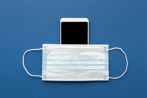 Flat lay medical mask smartphone