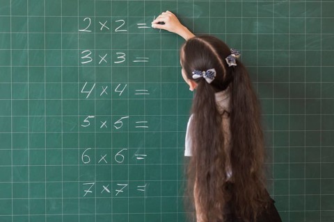 Girl making calculations blackboard