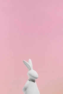 White rabbit figurine pink background