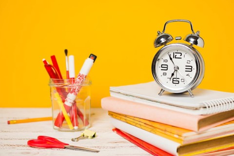 Back school concept clock pile books