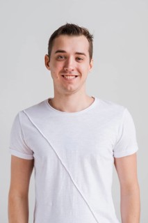 Smiling man white t shirt looking camera