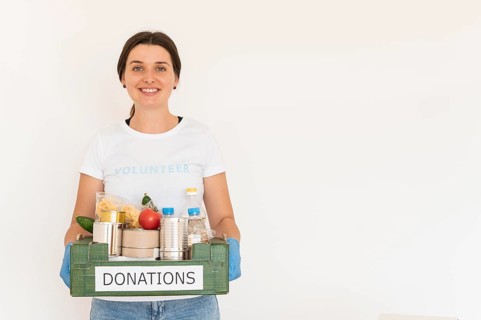 Female volunteer gloves handling box food donations