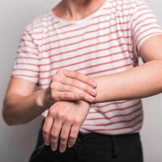 Mid section young woman having pain wrist
