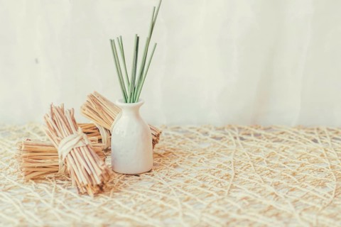 Vase with sticks near bunches sticks