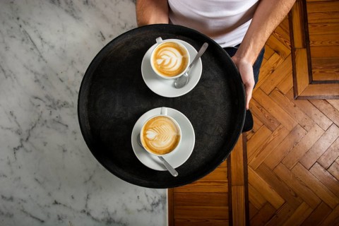 Two cups coffee with latte art tray