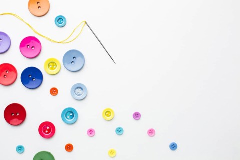 Clothes colourful buttons with needle