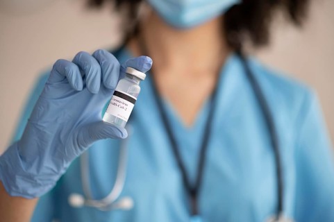 Female doctor preparing vaccine patient