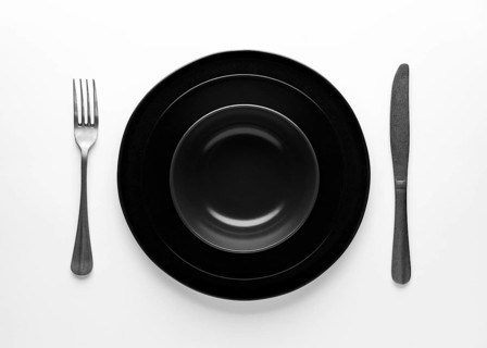 Flat lay dark dinnerware cutlery