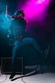 Artist playing guitar dancing