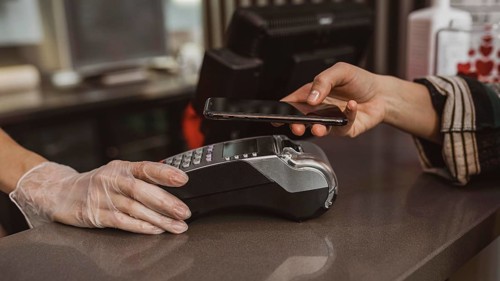 Close up customer paying her coffee bill