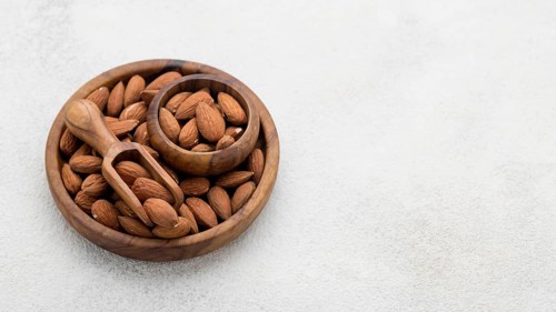 Organic almond nuts bowl copy space