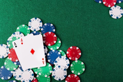 Two aces playing cards chips green poker table