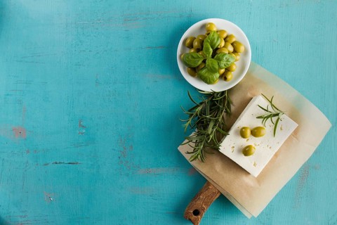 Blue background olives cheese aromatic herb