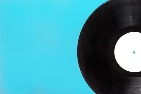 Single circular vinyl record blue background