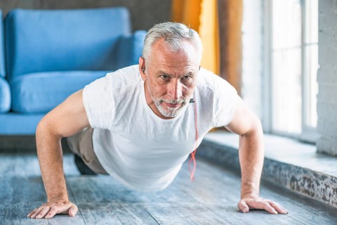 Senior man doing pushup home