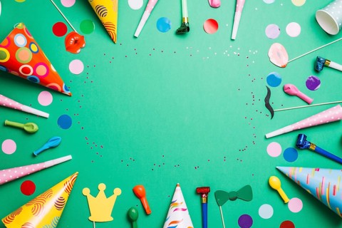 Colorful birthday frame multicolor party items green background