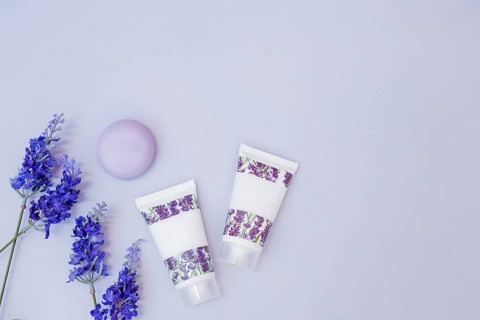 Fake lavender flower soap moisturizing cream colored background