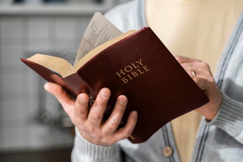 Front view man holding bible