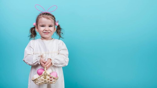 Little girl bunny ears holding basket with easter eggs