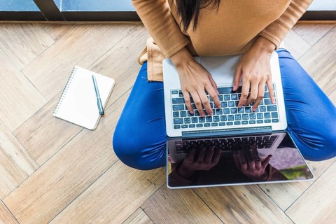 Woman typing laptop