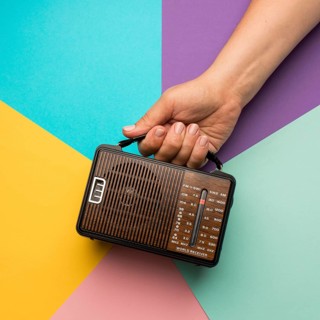 Person holding retro broadcast radio receiver