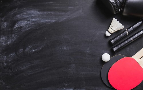 Blackboard background with ping pong rackets ball