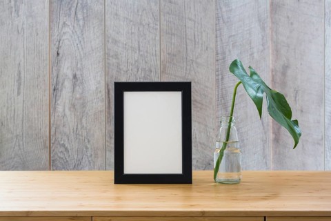 Monstera leaf glass bottle frame wooden table