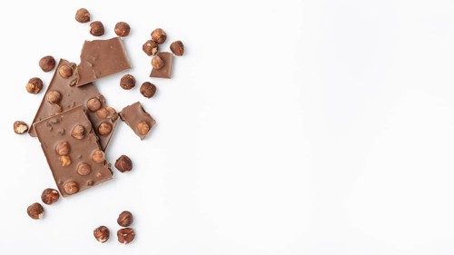 Top view chocolate with hazelnuts copy space