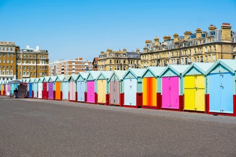 Row of beautiful colourful seaside bathing cottages in Brighton and Hove
