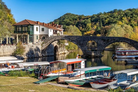Excursion boats at the Old Bridge Stari Most over the river Crnojevic in Rijeka Crnojevica
