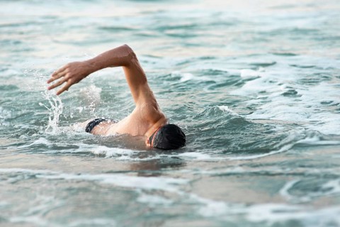 Male swimmer swimming ocean
