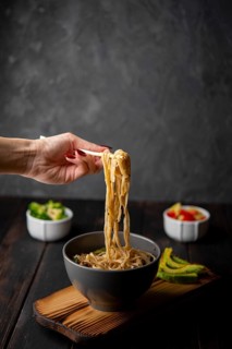 Noodles bowl with avocado copy space