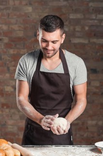Male baker preparing bread bakery