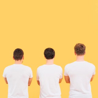 Rear view men white t shirt standing against yellow background