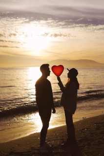 Couple heart balloon sea shore evening